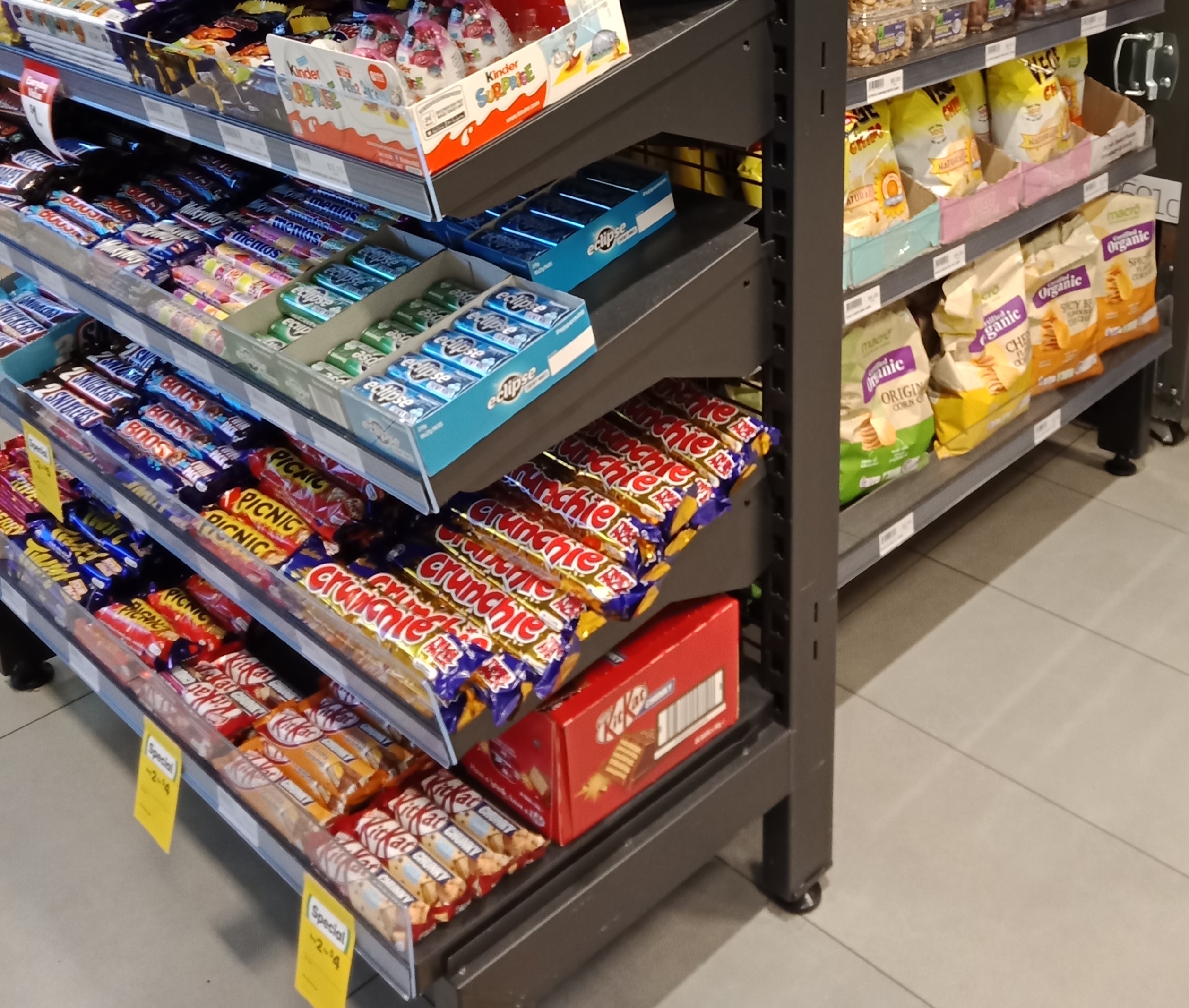 Sturdy metal shelving filled with groceries in a Foodary store, showcasing efficient retail display solutions.