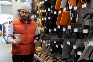 Man selecting tools in Australian construction hypermarket, shopping for building supplies and equipment