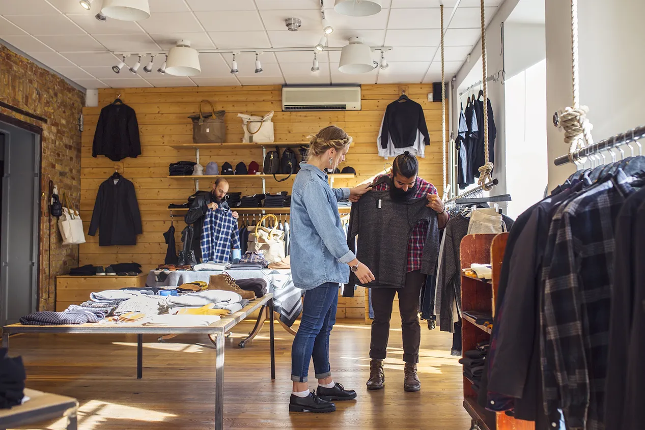 Group of friends shopping and choosing clothes in a Sydney store, enjoying fashion and style together in 2023.